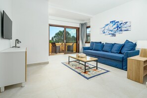 A modern living room with a sofa, a coffee table, a TV, and a balcony with a view.