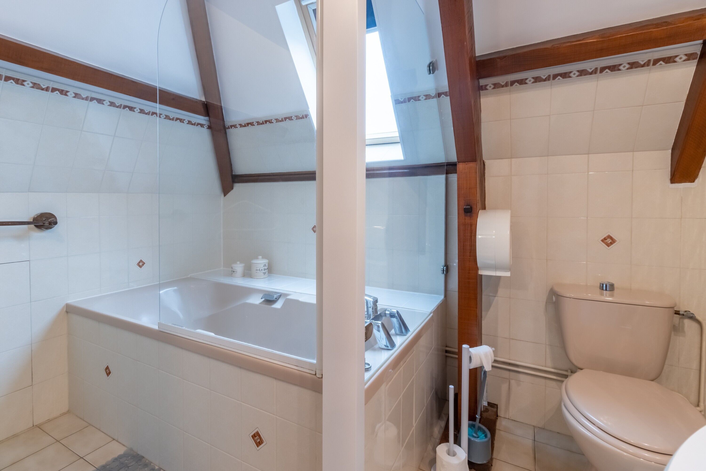 A bathroom with a bathtub, toilet, and sink.