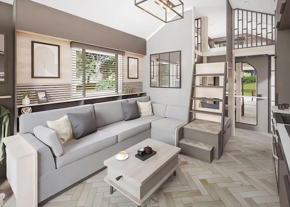A modern living room with a sectional sofa, a coffee table, and a staircase leading to an upper level.