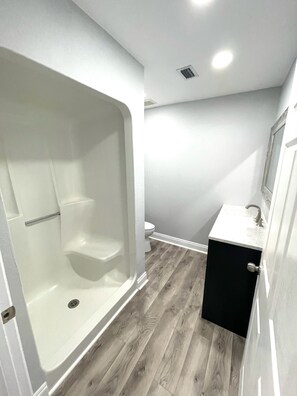 Shower, hair dryer, towels, toilet paper