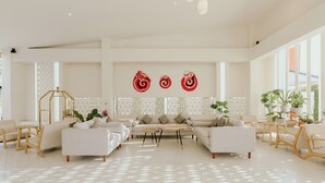 A spacious living room with a sofa set, coffee table, and decorative wall art. - Parima Hotel (Trang)