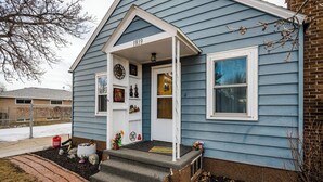 A house with a front porch, a mailbox, and a number '1839' on the door.