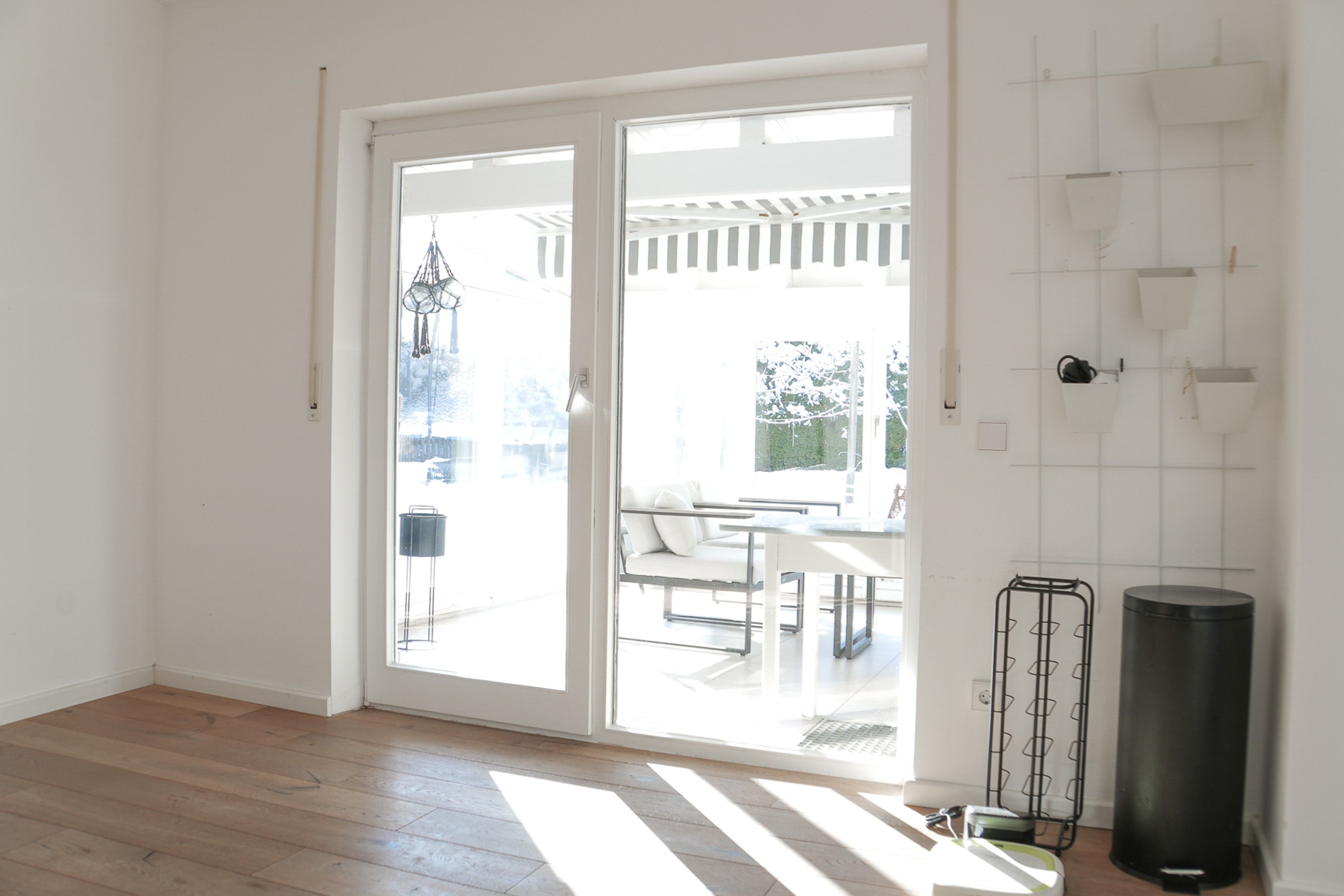 A bright room with a sliding glass door leading to an outdoor patio area.