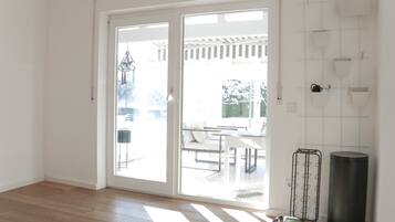 A bright room with a sliding glass door leading to an outdoor patio area.