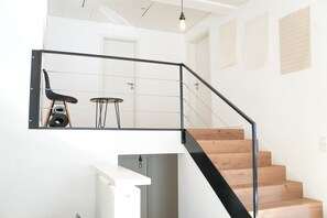 A staircase with a black handrail and wooden steps leading to an upper floor. - Holiday Home 'Landhausglück' with Private Terrace, Private Garden and Wi-Fi (Geislingen)