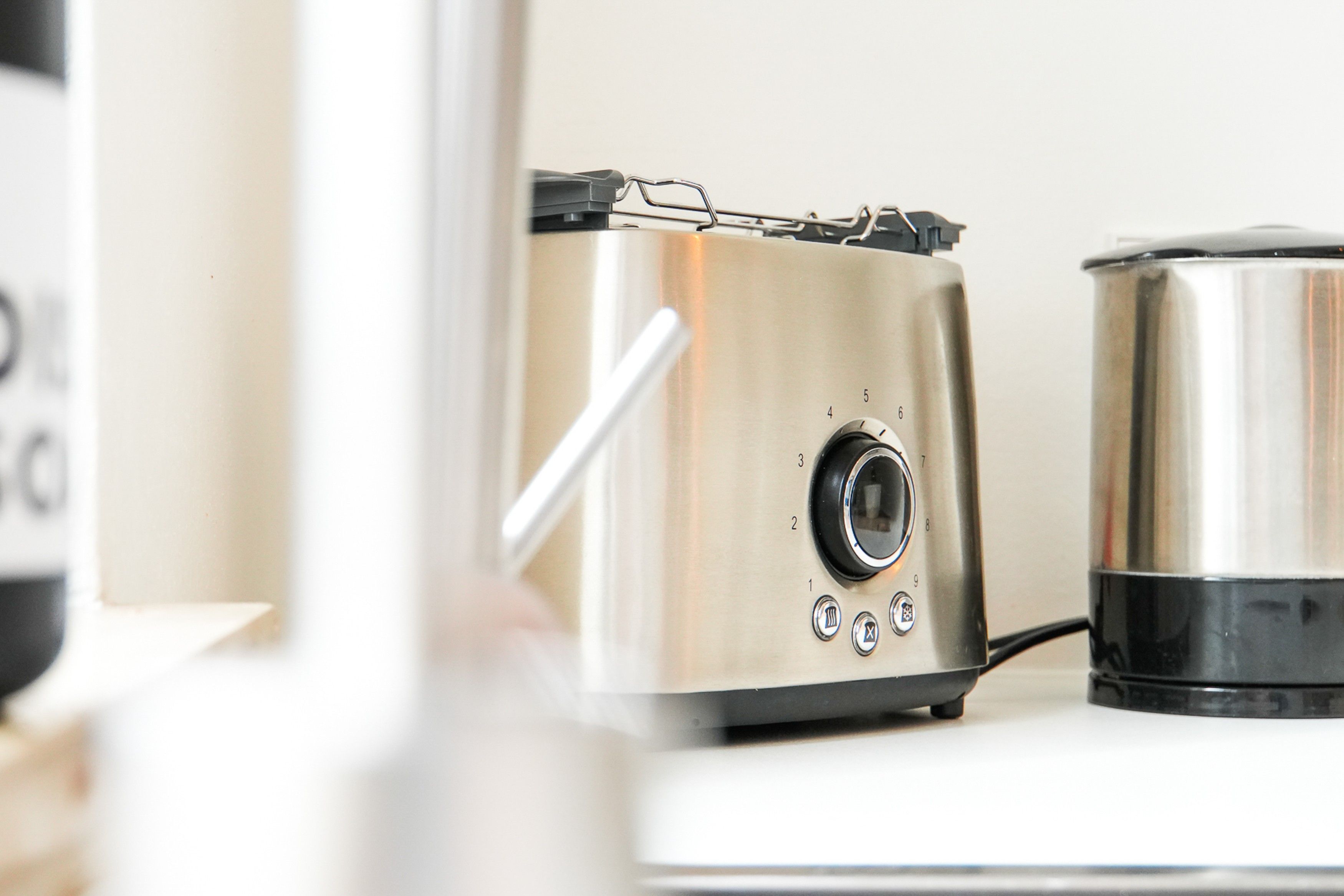 A stainless steel appliance with a dial and buttons, likely a coffee maker or similar device.