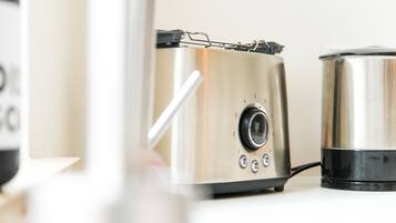 A stainless steel appliance with a dial and buttons, likely a coffee maker or similar device.
