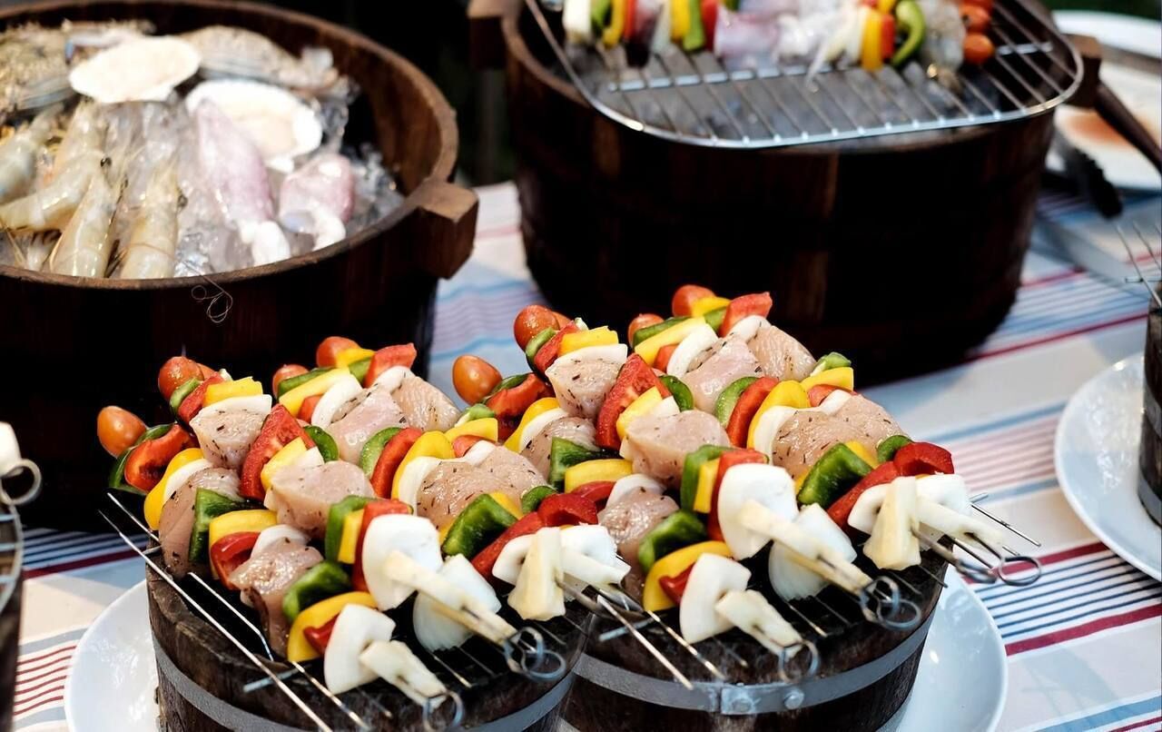 Skewers of meat and vegetables on a grill.