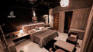 A modern bedroom with a large bed, bedside tables, a desk, and a chair. - Noah Crest (Kodaikanal)