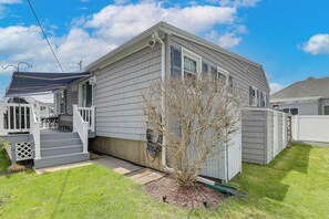 A residential house with a covered porch, a small tree, and a shed. - Near Beaches & Waterfront Dining: Home in Hampton! (Hampton)