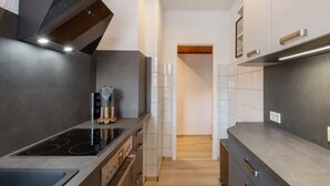 A modern kitchen with a built-in stove, oven, and a sleek backsplash.