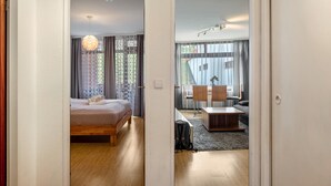 A bedroom with a bed, a desk, and a chair.