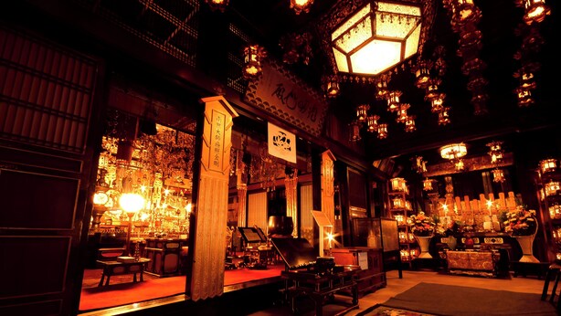 Un intérieur à la décoration traditionnelle, comprenant un comptoir d’accueil, un espace salon et une scène.
