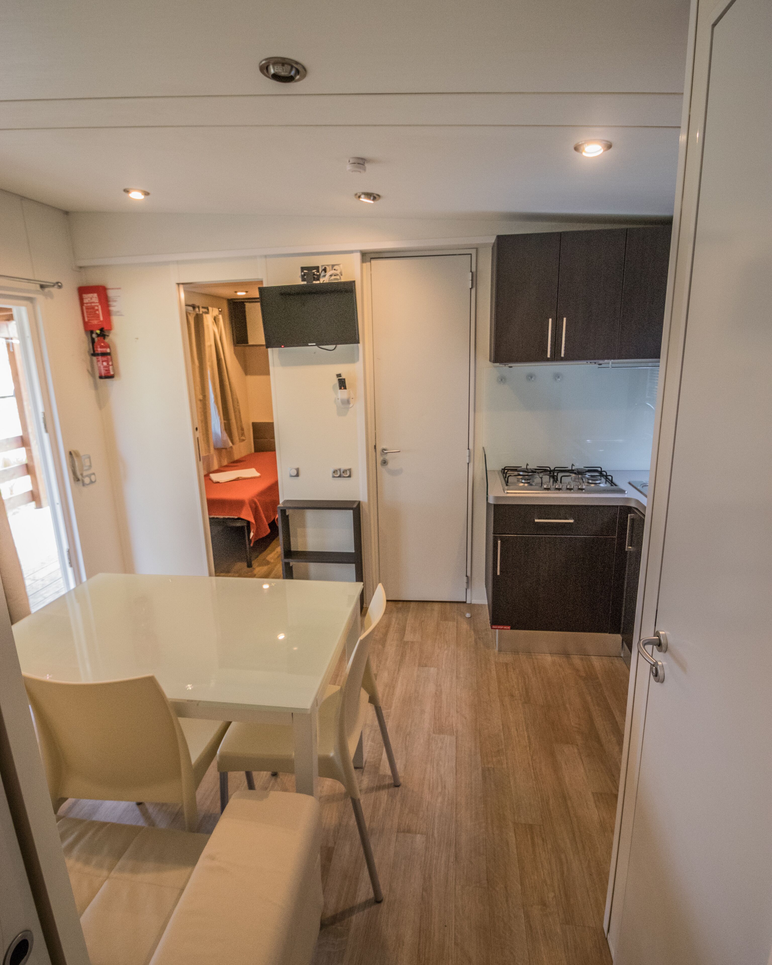 Una cocina compacta con comedor, una pequeña mesa y una estufa.