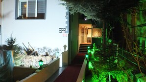A pathway leading to a building entrance with a sign indicating 'DOĞA' and 'APT. 14'. - ÇANKAYA BOUTİQUE HOTEL (Ankara)