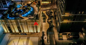 A hotel with a swimming pool, outdoor seating areas, and a modern architectural design. - Vũng Tàu Apartment - The Sóng Homestay (Ho Chi Minh City)