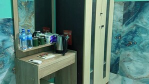 A bathroom with a wooden vanity, a mirror, a cabinet, and a tiled floor. - Wind Stay (Malé)
