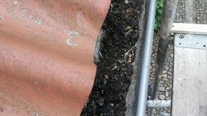 A metal gutter attached to a corrugated metal roof. - House not rented (Delebäck)