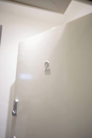 A door with a number '2' on it, a metallic handle, and a keyhole.