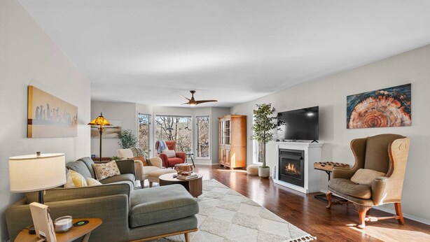 A living room with a fireplace, a television, and a large window. - Treetop Trailhaven-Direct Access to MTB Trails! (Bella Vista)