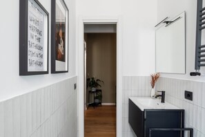 Shower, hair dryer, slippers, towels