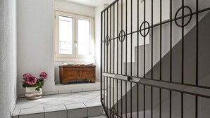 A staircase with a metal railing leading to a landing. - Ruga Vacation Rental 4 in Ascona (Ascona)