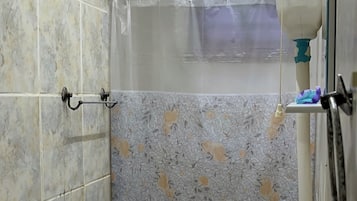 A bathroom with a toilet, sink, and shower curtain.