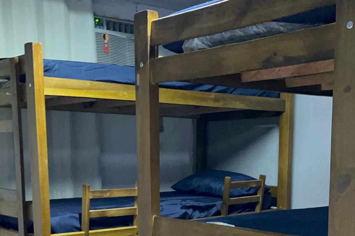 Bunk beds with blue bedding in a room with tiled flooring.