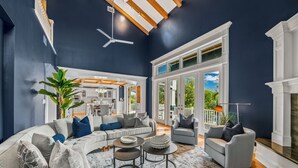A spacious living room with a large sectional sofa, a coffee table, and a fireplace. - Castle Azul: Luxury canal front w/pool, hot tub, putting green, and ping pong (Anna Maria)