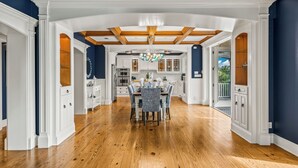 A spacious kitchen with white cabinetry, a wooden ceiling, and a dining area with a table and chairs. - Castle Azul: Luxury canal front w/pool, hot tub, putting green, and ping pong (Anna Maria)