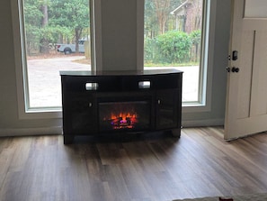 Enjoy a cozy atmosphere with a fireplace and a view of the surrounding neighborhood.