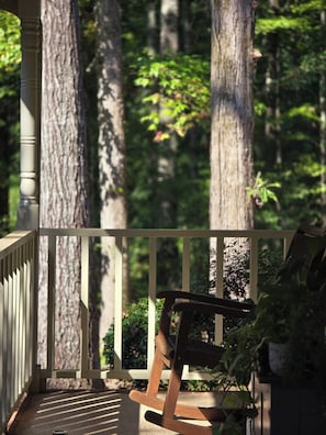 Sit on the porch and enjoy the serene forest view.
