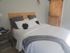 Restful retreat with a comfortable bed, wooden headboard, and convenient nightstands.