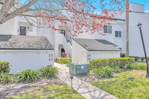 A row of numbered white buildings with a pathway leading to a door. - Fairway Breeze: Sawgrass Golf Course Views | Pool + Beach Access (Ponte Vedra Beach)