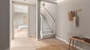 Un passadís amb una escala que condueix a una habitació.