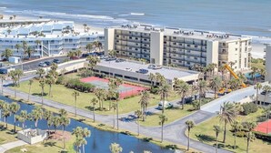 A hotel with multiple buildings, a parking lot, and a beach view. - Crescent Breeze - Oceanfront w/incredible views, lanai & pool (St. Augustine)