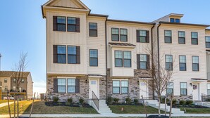 A multi-story residential building with a symmetrical facade, large windows, and a central entrance with steps. - 2 Mi to Dtwn Frederick: Updated Townhome (Frederick)