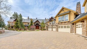 A large, multi-story house with a driveway and garage.
