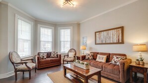 A living room with two sofas, a coffee table, and a chair. There are two lamps on side tables. - Updated & Charming! Home Near Douthat State Park (Clifton Forge)