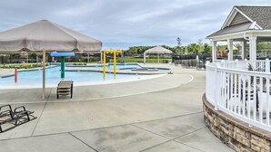 A swimming pool area with umbrellas, lounge chairs, and a gazebo. - 6 Mi to Bethany Beach: Family Home w/ Pool Access! (Millville)