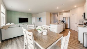 A modern kitchen with white cabinets, a stainless steel refrigerator, and a built-in oven. - 6 Mi to Bethany Beach: Family Home w/ Pool Access! (Millville)