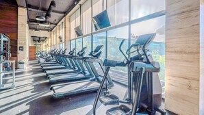 A gym with multiple treadmills and exercise equipment arranged in rows. -  2BR GROUND floor: Pool, Hot tub, Big Gym, Beach Access LUX AWA Playacar (Playa del Carmen)