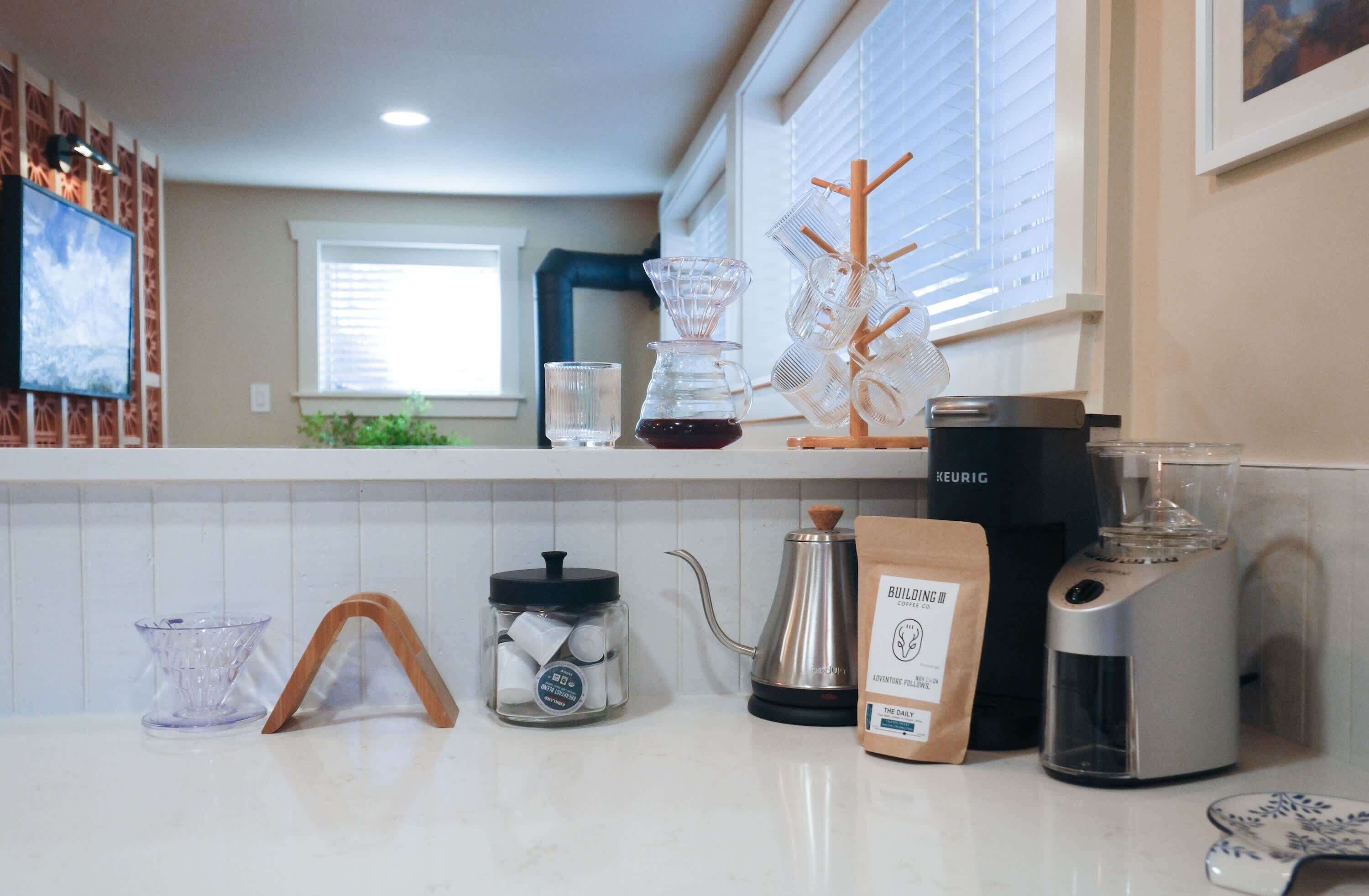 Coffee with keurig and pods, local coffee, pour-over, coffee grinder and kettle.