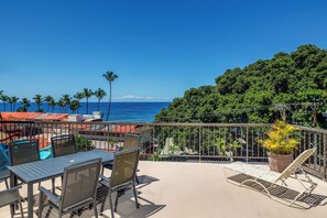 A terrace with a view of the ocean, outdoor seating, and a potted plant. - Kona Plaza#302: Third Floor, Ocean View in Heart of Kona Town, Ac & Elevators (Kailua Kona)