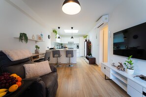Relax in this cozy living space with a leather sofa, coffee table, and flat-screen TV.