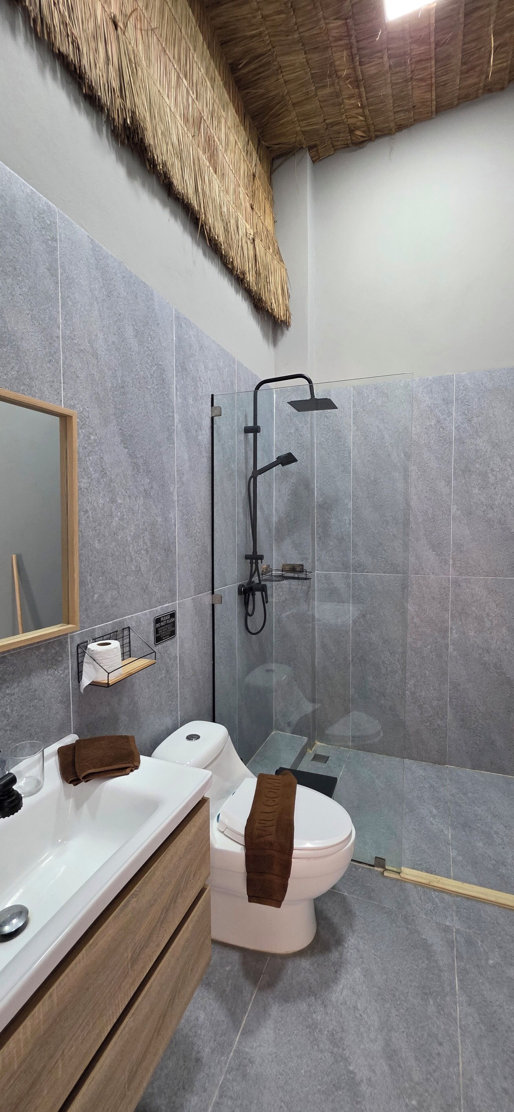 A bathroom with a shower, toilet, and vanity.
