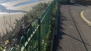 A coastal walkway with a view of the beach and cliffs. - The Beach Retreat Apartment, Balcony views of shanklin bay. (Shanklin)