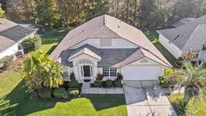 A single-story house with a sloped roof, a front entrance with a small porch, and a well-maintained lawn.