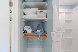 A bathroom with a towel rack, a shelf with folded towels, and a shower area. - 🌊Walk to Beach-Pet Friendly-Cozy 1 Bedroom-Island Paradise 6🌊 (Fort Myers Beach)
