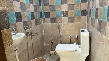 A bathroom with a sink, toilet, and shower.